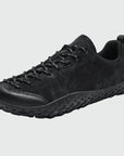 Dannto black barefoot trail shoes shown from a three quarter view